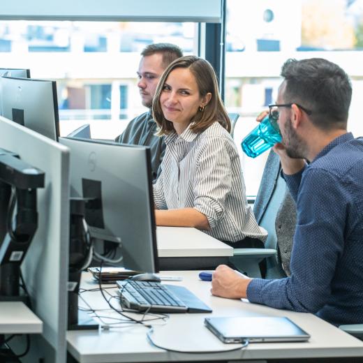 A photo of two people working together in the office